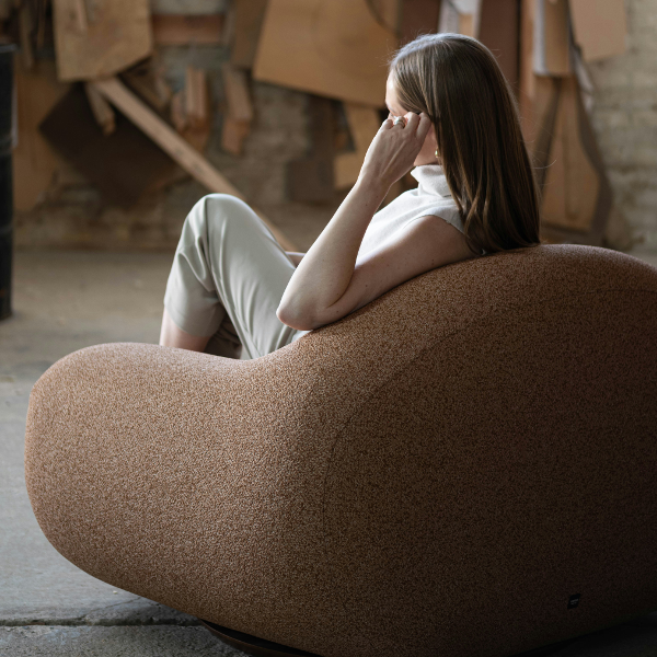 Woman comfortably taking ID photo on a sofa at home
