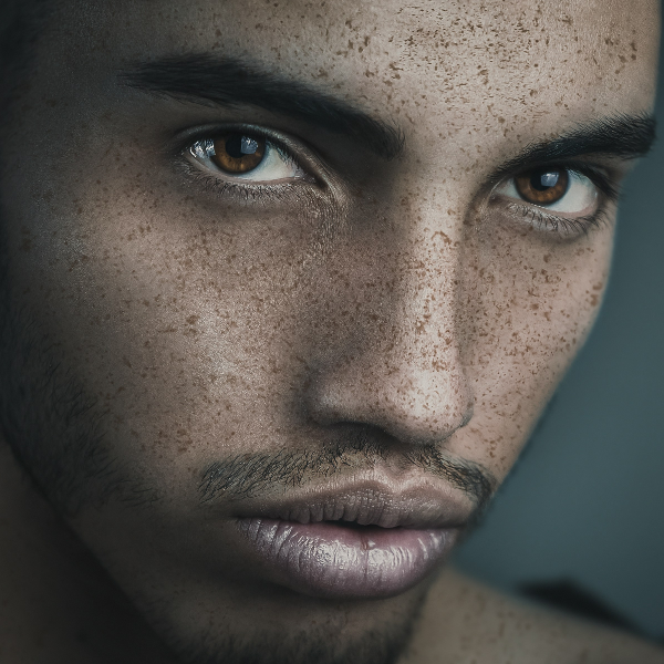Close-up portrait of a young man in natural, flattering lighting